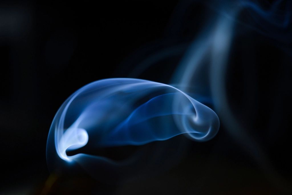 A soft blue cloud of smoke in the dark
